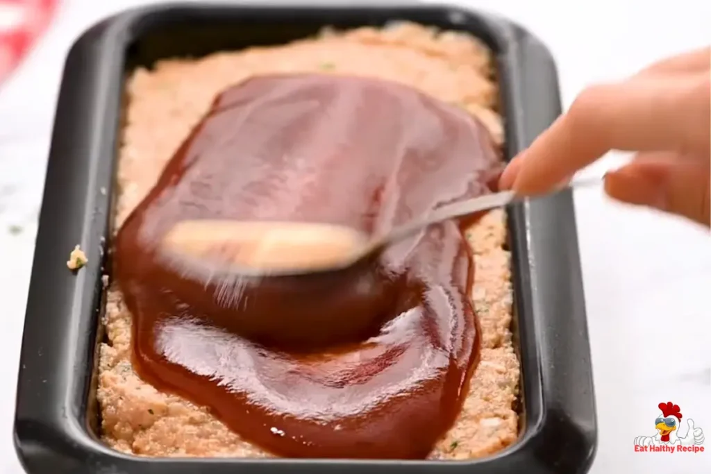 Shaping and glazing a homemade chicken meatloaf